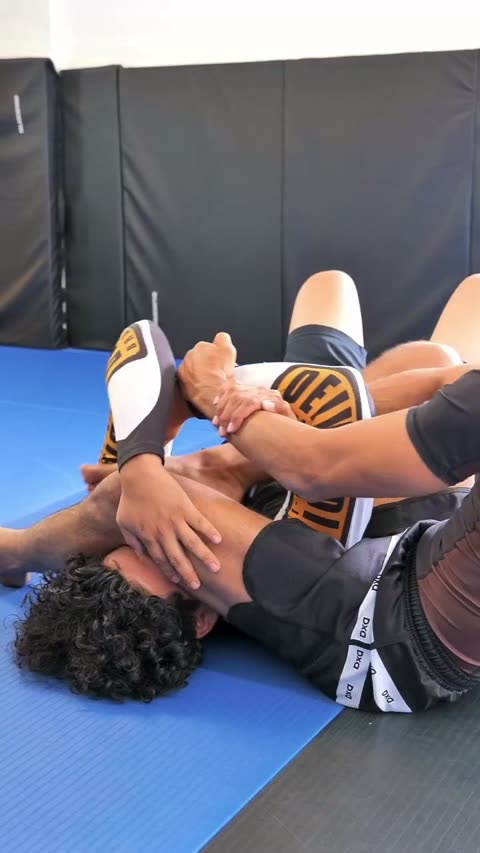 Arm-bar to triangle transition